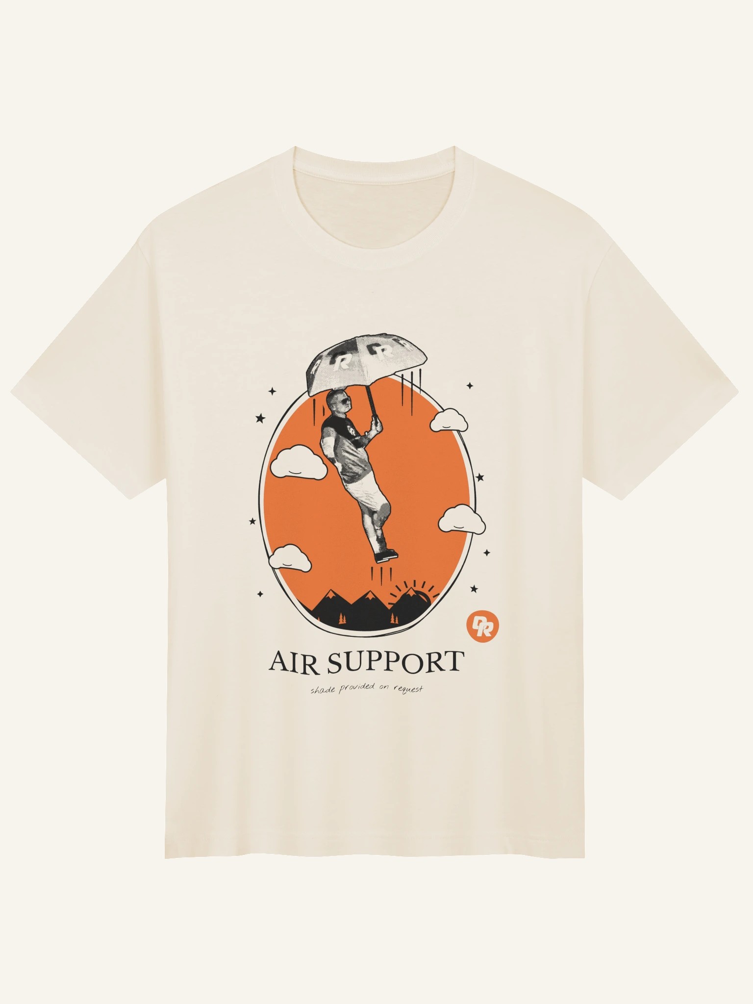 Cream baggy-fit tee with an illustration of a figure under an umbrella in an orange oval and the words Air Support.